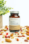 Bottle of Udo's Choice Digestive Enzymes Gold on a background with nuts and seeds.
